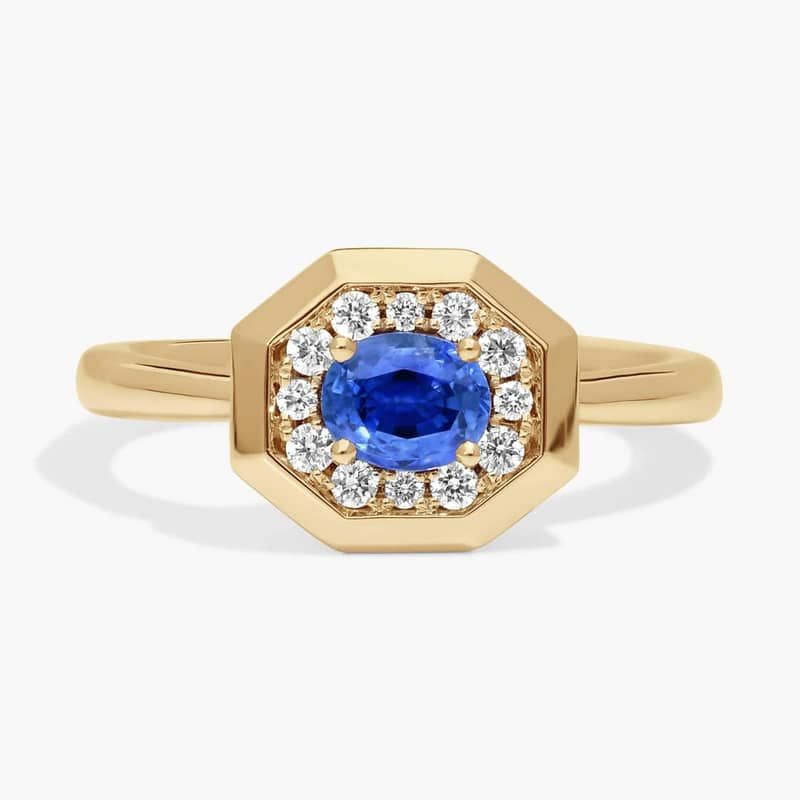 East-West Oval Cut Blue Sapphire and Pavé Diamond Ring In 14K Yellow Gold