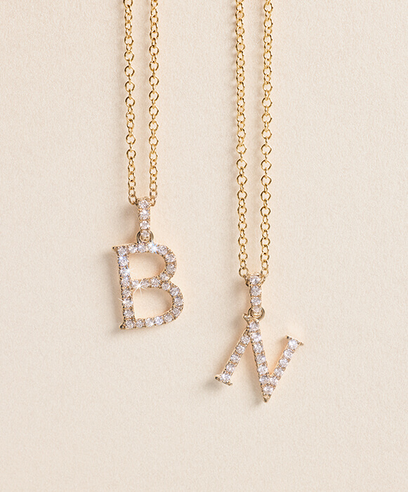 yellow gold diamond initial pendant necklace with letters B and N